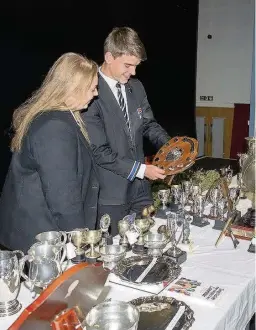  ??  ?? Achievemen­t Katriona Taylor and Duncan Lambie admire the many trophies