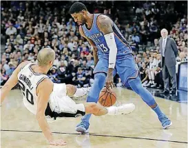  ?? [AP PHOTO] ?? Oklahoma City’s Paul George, right, collides with San Antonio’s Manu Ginobili during Friday night’s NBA game in San Antonio.