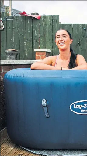  ??  ?? Jacqueline Flanagan, right, is joined by daughter Kathleen in the hot tub at home in Bellshill, Lanarkshir­e