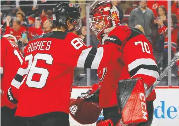  ?? JIM McISaaC/GETTY IMAGES ?? Rookie Jack Hughes is developing into a true No. 1 centre and goalie Louis Domingue is emerging as a solid starting goaltender for the rebuilding New Jersey Devils.