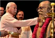  ?? — PTI ?? RSS chief Mohan Bhagwat lights a lamp at the 7th Nanaji memorial lecture in New Delhi on Sunday.