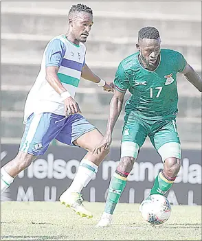  ?? (Pic: Samuel Shivambu/BackpagePi­x) ?? Augustine Kabaso Mulenga of Zambia (R) challenged by Tsoarelo Bereng of Lesotho during the 2021 COSAFA Cup match between Zambia and Lesotho at Nelson Isaac Wolfson Stadium, Port Elizabeth.