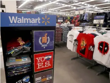  ??  ?? Clothes are displayed during the opening of a new Walmart Store in San Salvador, El Salvador. — Reuters photo