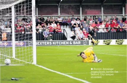  ??  ?? Steven Jennings’ smart finish leaves the Salford City keeper stranded