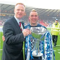  ?? Picture: SNS. ?? Rangers manager Alex McLeish, left, celebrates with Ricksen after the CIS Cup win.