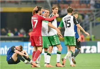  ?? AFP ?? Sassuolo players celebrate after winning their Italian league match against Inter Milan at the San Siro stadium in Milan on Saturday. Sassuolo won 2-1. —