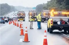  ?? MICHAEL DWYER/AP ?? Traffic on Interstate 95 is diverted Saturday in the area of an hourslong standoff with a group of armed men that partially shut down the highway in Wakefield, Mass.