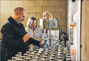  ??  ?? Fin and Eileen hard at work in their gin distillery on Colonsay, where they offer 'gin lovers' retreats'.
