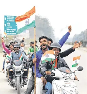  ??  ?? Gesture: Residents on the Indian side of the border celebrate before the arrival of an Indian Air Force pilot who was captured by Pakistan.