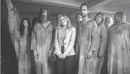  ?? CBS ?? Rose McIver, center, in a scene from the comedy series “Ghosts.”