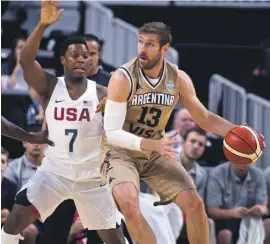  ??  ?? U.S. guard Kyle Lowry defends Argentina forward Andres Nocioni