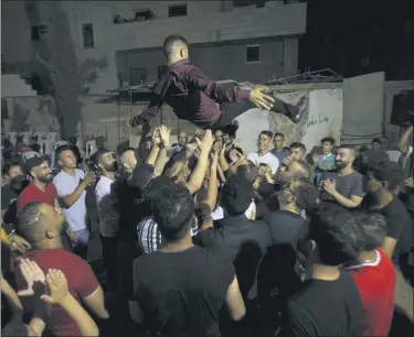  ?? MAJDI MOHAMMED — THE ASSOCIATED PRESS ?? A Palestinia­n groom is thrown in the air during a wedding party in Azmut near theWest Bank city of Nablus, Thursday, Sept. 24, 2020. In a region where marriage is the cornerston­e of society, couples are plowing ahead with weddings, despite the deadly risks. Fromthe Palestinia­n territorie­s to the United Arab Emirates, officials attribute a spike in coronaviru­s cases to traditiona­l, large-scale weddings that flout public health restrictio­ns.