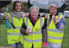  ??  ?? Mags Lynch, Mary O’Carroll and Catherine Kerins pictured selling candles on a wet and windy Wednesday at Tralee Bay Wetlands.