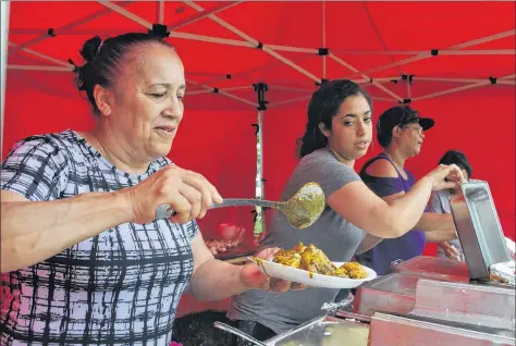  ??  ?? Myrna Ritchie (from left), Shantel Berry and Rachel Fells of Yarmouth, serve up buffet fare at the Journey Back to Birchtown celebratio­n at the Black Loyalist Heritage Centre and Historical Site on the July 14 weekend.