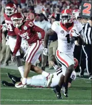  ?? CURTIS COMPTON / The Associated Press ?? Georgia’s Sony Michel breaks away from the Oklahoma defense for the game-winning 27-yard touchdown run in double-overtime on Monday night.