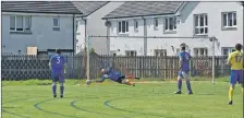  ?? 01_B20AHCfina­l02 ?? The Brodick keeper manages to deflect the ball at the end of his reach.