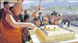  ?? TWITTER ?? Tibetan spiritual leader the Dalai Lama cutting his birthday cake in Leh on Friday.