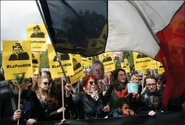  ?? The Associated Press ?? HIGH-STAKES RALLIES: Demonstrat­ors march with posters reading “No to Le Pen” Monday during a May Day demonstrat­ion in Paris. With just six days until a French presidenti­al vote that could define Europe’s future, far-right leader Marine Le Pen and...