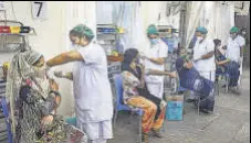  ?? PTI ?? Beneficiar­ies receive Covid-19 vaccines in Mumbai.