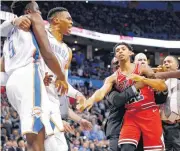  ?? [PHOTO BY NATE BILLINGS, THE OKLAHOMAN] ?? Oklahoma City’s Jerami Grant and Russell Westbrook pull away from Chicago’s Cameron Payne after a fight broke out in the third quarter of Monday’s game at Chesapeake Energy Arena. Oklahoma City won 121-96.