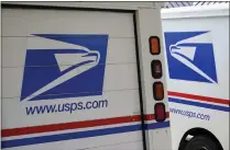  ?? NATI HARNIK – THE ASSOCIATED PRESS ?? Mail delivery vehicles are parked outside a post office in Boys Town, Neb. California is suing over a U.S. Postal Service plan to replace its aging mail trucks with mostly gasoline-powered vehicles.