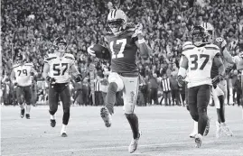  ?? QUINN HARRIS Getty Images ?? The Packers’ Davante Adams finishes off a 40-yard touchdown catch from Aaron Rodgers against the Seahawks in the third quarter. Adams had two TD catches for Green Bay.