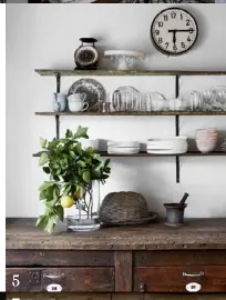  ??  ?? 5. An industrial-style clock and sturdy mortar and pestle add a rustic touch.