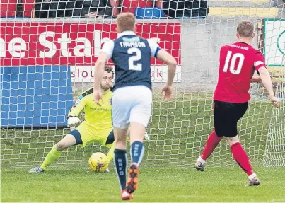  ?? Picture: SNS. ?? Ross Caldwell gives the home side the lead from the penalty spot.