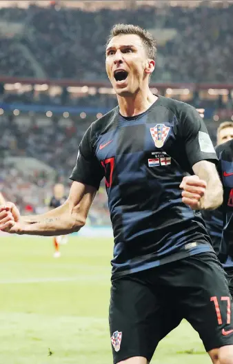  ?? FRANK AUGSTEIN/THE ASSOCIATED PRESS ?? Croatia’s Mario Mandzukic celebrates after scoring against England to break a 1-1 tie in extra time in Wednesday’s World Cup semifinal in Moscow. Croatia faces France in Sunday’s final.