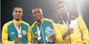  ?? /AFP ?? Medal detectors: Akani Simbine, centre, Henricho Bruintjies, left, and Yohan Blake on the podium on Monday. .