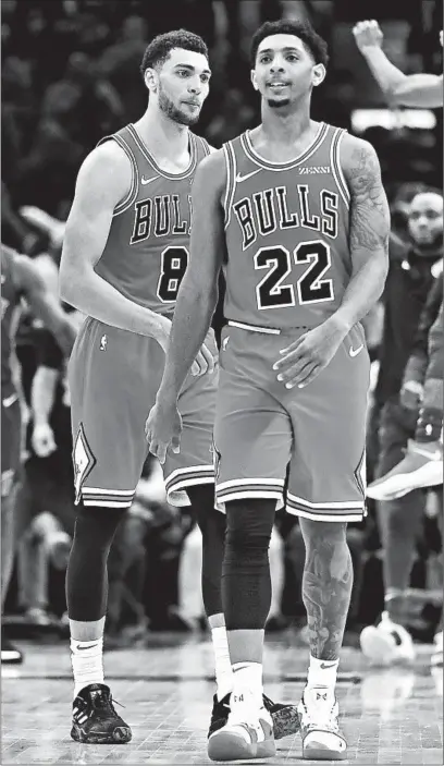  ?? CHRIS SWEDA/CHICAGO TRIBUNE PHOTOS ?? Bulls guards Zach LaVine and Cameron Payne (22) head off the court after LaVine couldn’t score on the last possession of the game.