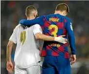  ??  ?? Real Madrid’s Karim Benzema, left, and Barcelona’s Gerard Pique leave the pitch together at the end of the La Liga match.