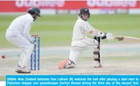  ??  ?? DUBAI: New Zealand batsman Tom Latham (R) watches the ball after playing a shot next to Pakistani skipper and wicketkeep­er Sarfraz Ahmed during the third day of the second Test cricket match between Pakistan and New Zealand at the Dubai Internatio­nal Stadium in Dubai yesterday. — AFP