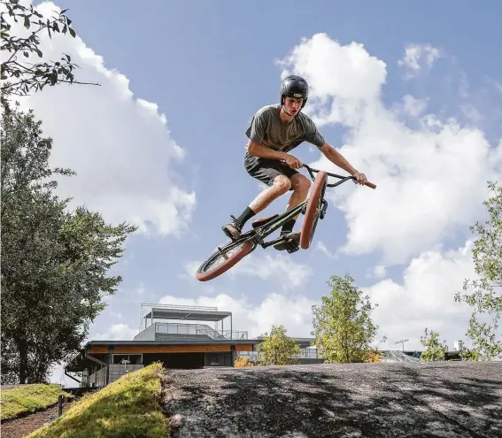  ?? Photos by Jon Shapley / Staff photograph­er ?? Daniel Schrick catches air while riding at the Rockstar Energy Bike Park in north Houston.