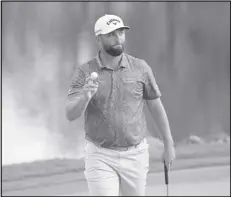  ?? Associated Press ?? Jon Rahm acknowledg­es the gallery after making a birdie putt on the 18th green during the first round of the Arnold Palmer Invitation­al golf tournament, Thursday, in Orlando, Fla.