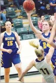  ?? Westside Eagle Observer/MIKE ECKELS ?? Lavaca’s Avery Green (11) goes down as Sammie Skaggs (Decatur 24) shoots a jumper during the Lavaca-Decatur girls’ basketball contest in the gym at Danville High School in Danville Feb. 20. The Lady Golden Arrows defeated the Lady Bulldogs, 57-32, in the opening round of the 2A West Regional basketball tournament.