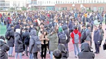  ??  ?? University students stand in an open space to take shelter after a 5.4-magnitude earthquake in the southeaste­rn port city of Pohang. — AFP photo