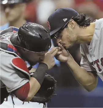  ?? AP PHOTO ?? FINISHING TOUCH: Joe Kelly celebrates with catcher Christian Vazquez after closing out the Sox' win over the Rays yesterday.