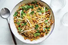  ?? Linda Xiao, © The New York Times Co. ?? This satisfying bowl gets its bite from farro, its crunch from spiced chickpeas, and its sweetness from roasted corn and slivered fennel.