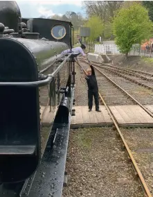  ?? (David Bissett) ?? The crew of 0-6-0 tank No 7714 swap tokens with the signalman at Highley on May 1. It’s so good to be able to see the ‘old way’ back in action again.