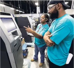  ?? AP ?? In this Wednesday, August 30 photo, employees Stephen Cheek and Lashanda Mitchell test automated teller machines during the manufactur­ing process at Diebold Nixdorf in Greensboro, North Carolina. This year, 2017, marks the 50th anniversar­y of the ATM.