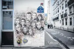  ?? STEPHANE DE SAKUTIN/GETTY-AFP 2019 ?? A painting pays tribute to members of the Charlie Hebdo newspaper who were killed in January 2015 in Paris.