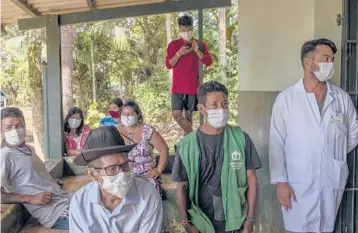  ?? VICTOR MORIYAMA/THE NEW YORK TIMES ?? Brazilian indigenous people wait last week in Sao Paulo to receive the vaccine from the Chinese company Sinovac. Brazilian officials have complained that Chinese companies have been slow to ship the doses.