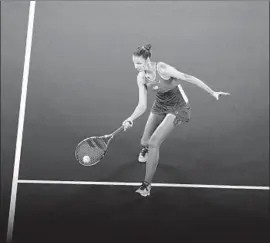  ?? Manan Vatsyayana Getty Images ?? KAROLINA PLISKOVA returns a shot against Laura Siegemund en route to a 6-3, 6-3 victory in a women’s second-round match at the Australian Open.