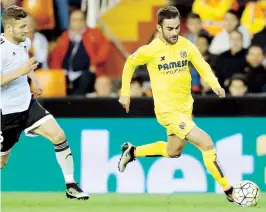  ??  ?? El delantero del Villarreal Adrián López escapa del alemán Mustafi, del Valencia, durante el partido de Liga en Primera División ayer en el estadio de Mestalla.