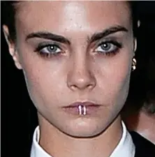  ?? ?? Model mouthpiece: Showing off her punky side without committing to a piercing, Cara Delevingne has a collection of gold lip rings