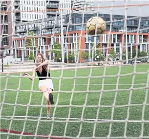  ?? RICHARD LAUTENS/TORONTO STAR ?? Alexandra Karges kicks a soccer ball on Shuter St. near Parliament St. in Toronto. The city’s love for soccer is clear after its part in North America’s winning FIFA World Cup 2026 bid.