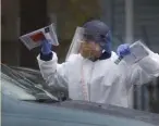  ?? nancy lane/ Herald staFF FIle ?? GATHERING INFO: A medic al worker takes part in testing at a drive-thru site at Somerville Hospital late last month.