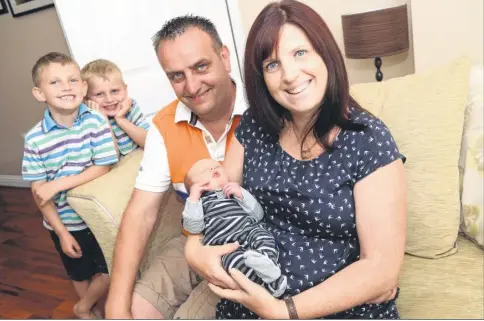  ?? Picture: Gary Browne FM2713223 Buy pictures from kentonline.co.uk ?? David and Kat Sharp with baby George and their sons Charlie, six and Thomas, four