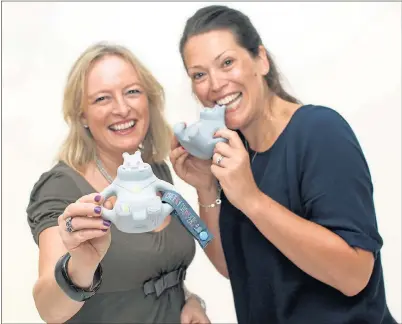  ??  ?? SUCCESS: Julie Wilson and Amy Livingston­e, founders of Cheeky Chompers, with Chewy – the latest addition to their range.